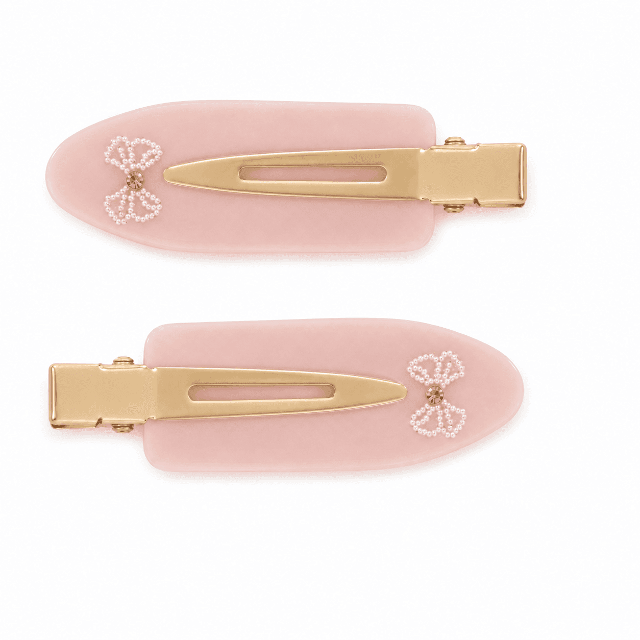 A pair of soft pink Blush Bow pintail clips with a bow in white beads and a pink stone centre.