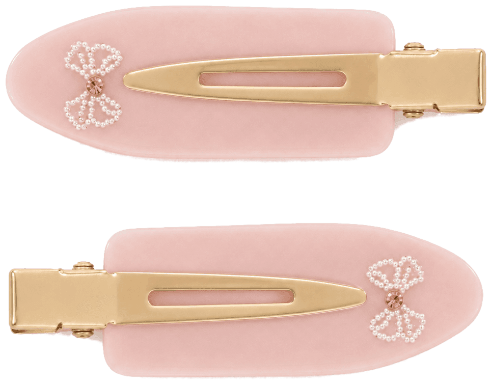 A pair of soft pink Blush Bow pintail clips with a bow in white beads and a pink stone centre.