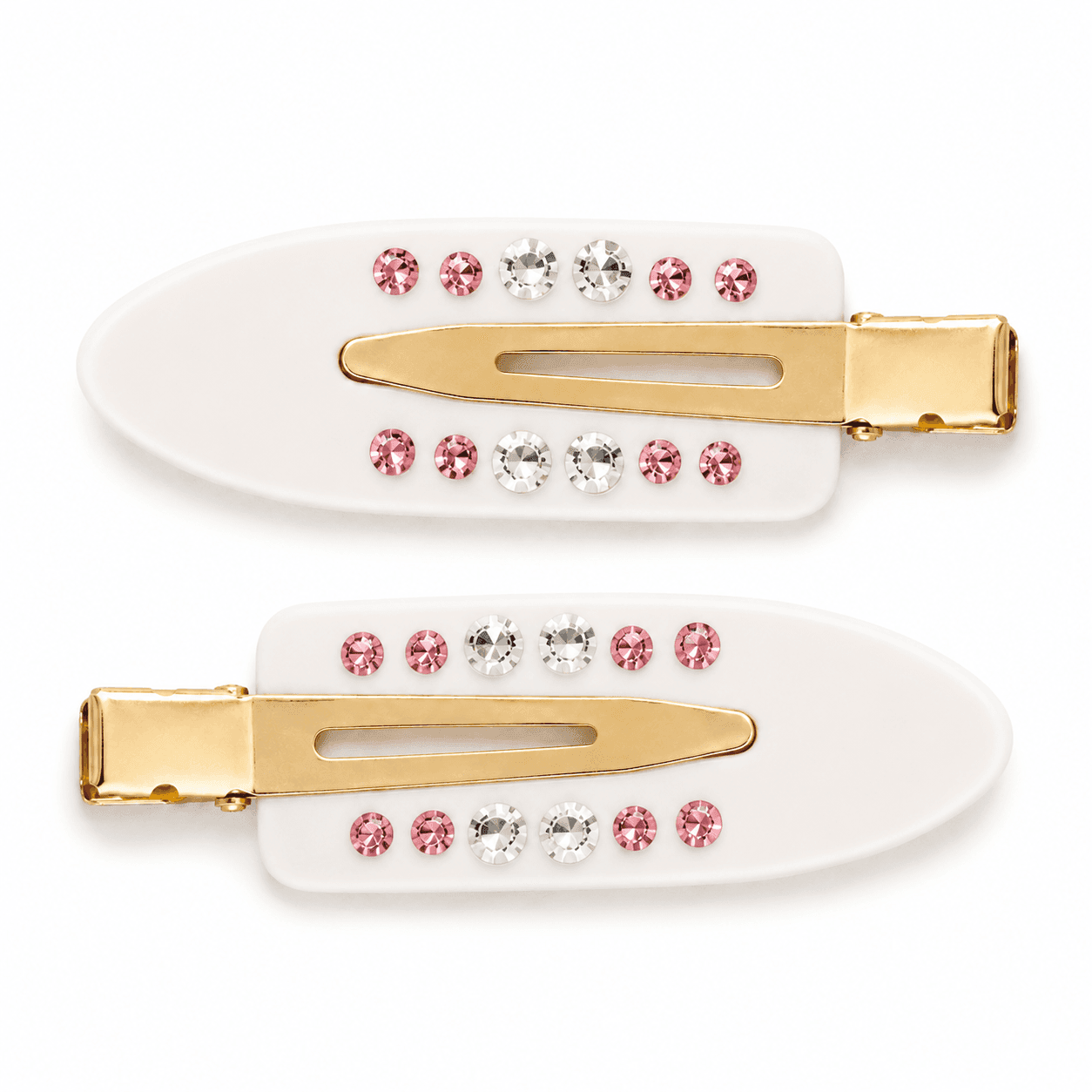 A pair of white Confetti pintail clips with gold hardware and rows of pink and clear stones.