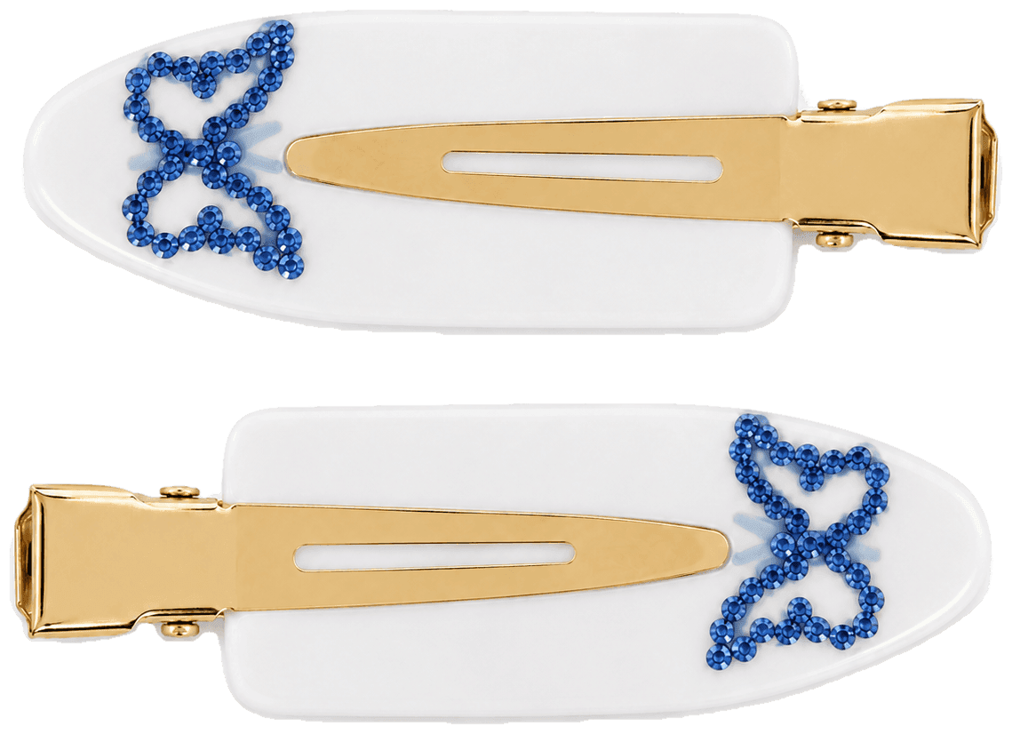 A pair of white Cornflower pintail clips with a bow outlined in blue stones.