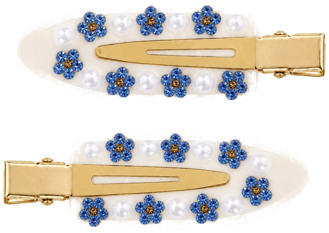 A pair of ivory Daisy pintail clips with blue flowers and round white beads.